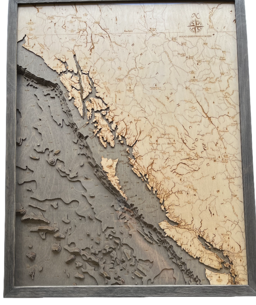 British Columbia Coast 3D wood wall map in a grey frame, angled view showing the laser-cut depth layers
